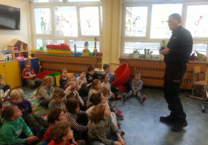 Pan Policjant omawia zasady bezpieczeństwa w drodze do szkoły i poza szkołą.