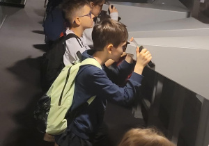 Uczniowie zwiedzają wystawę w Muzeum Przyrodniczym.
